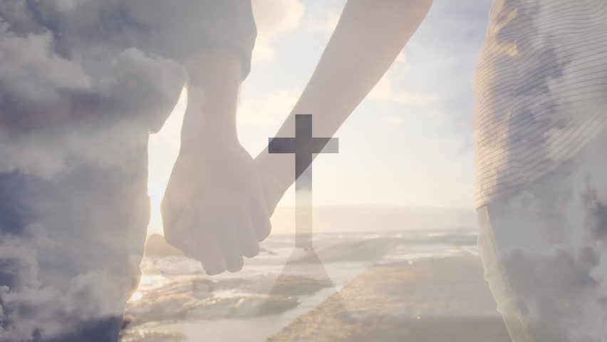 Animation of cross on mountain over midsection of diverse couple holding hands and walking at beach. Digital composite, multiple exposure, religion, crucifix, love, togetherness concept.