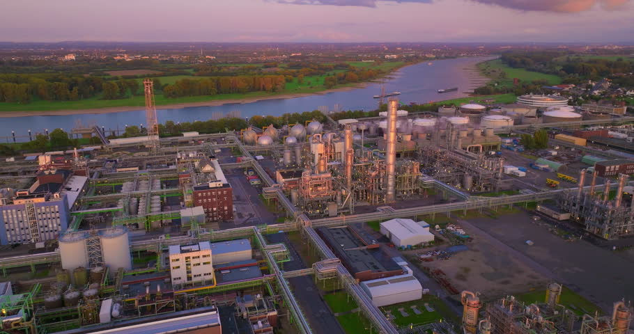 Establishing aerial footage of chemical plant. Chemical plant pumping out smoke and steam. Industrial air pollution. Oil and gas petroleum refinery. Air quality and environmental impact theme | Shutterstock HD Video #1111926277