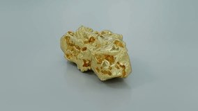 Raw gold nugget gleams against neutral backdrop. - Powered by Shutterstock - Get 15% off with code: PIKWIZARD15