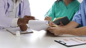 Medical analysts meeting nurses, pharmacists, doctors consulting with paperwork of graphs data charts results of medical research. Healthcare staff discussing innovation in hospital conference room. - Powered by Shutterstock - Get 15% off with code: PIKWIZARD15