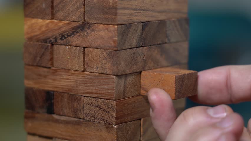 Hands of boy and girl play construction  blocks with pieces of wood  - games for creative fun in free time at home in apartment lifestyle - exercise of balance and intelligence | Shutterstock HD Video #1111930001