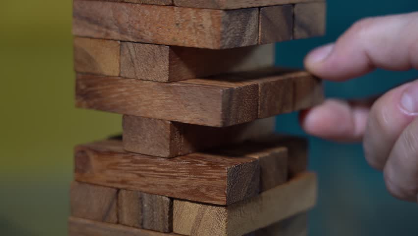 Hands of boy and girl play construction  blocks with pieces of wood  - games for creative fun in free time at home in apartment lifestyle - exercise of balance and intelligence | Shutterstock HD Video #1111930003