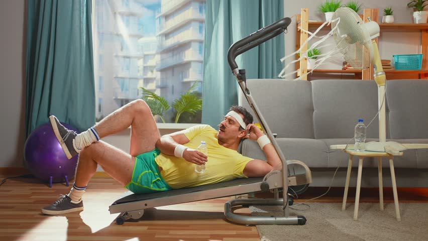 lazy funny athlete with a mustache lies treadmill in the living room Royalty-Free Stock Footage #1111930547