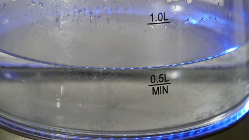 Timelapse. Water boils in a transparent glass electric kettle | Shutterstock HD Video #1111931175