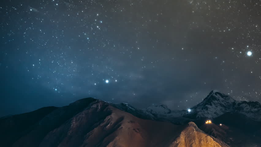 Stepantsminda, Georgia. Georgian Landscape In Winter Season. Hyperlapse Night Bright Starry Sky With Glowing Stars Above Peak Of Mount Kazbek Covered With Snow. | Shutterstock HD Video #1111932787
