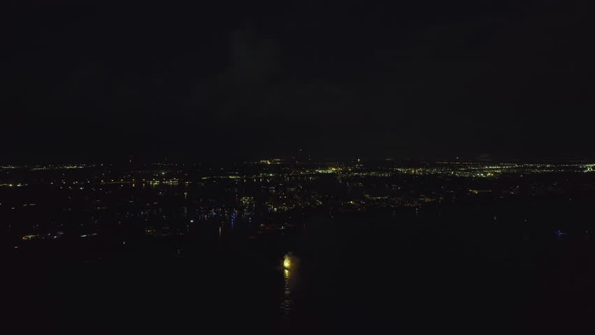 Aerial view of bright fireworks exploding with colorful lights over sea shore on US Independence day holiday