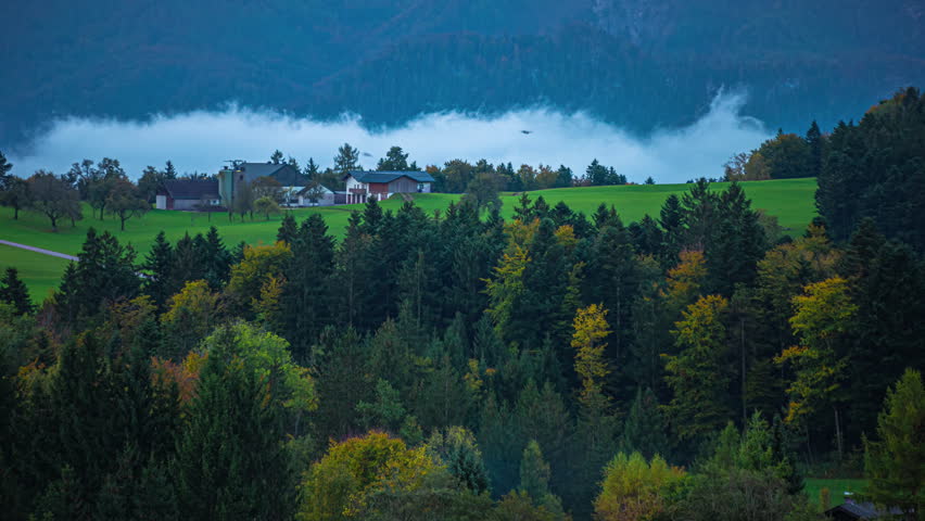 Timelapse looking across valley in Oberwang, Austria. Low cloud bubbling up in the distant valley