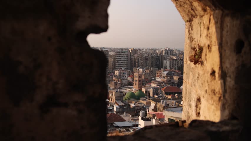 view looking through an old stone window down towards old town of Tripoli, Northern Lebanon Royalty-Free Stock Footage #1111944455
