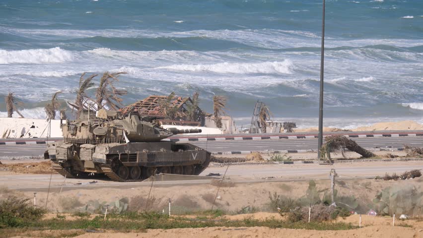 An Israeli Merkava Mark IV Barak tank moving slowly along the coastline  Royalty-Free Stock Footage #1111944881