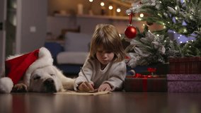 Precious child and furry dog immersed in holiday preparations, writing letter to Santa Claus in beautifully adorned room. Magic of Christmas. Cinematic AD. Concept of waiting for gifts from Santa