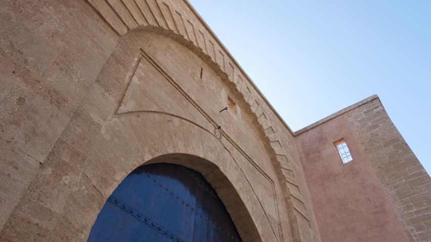 Tilt down along Bab Laalou large wooden keystone gate in Rabat Morocco