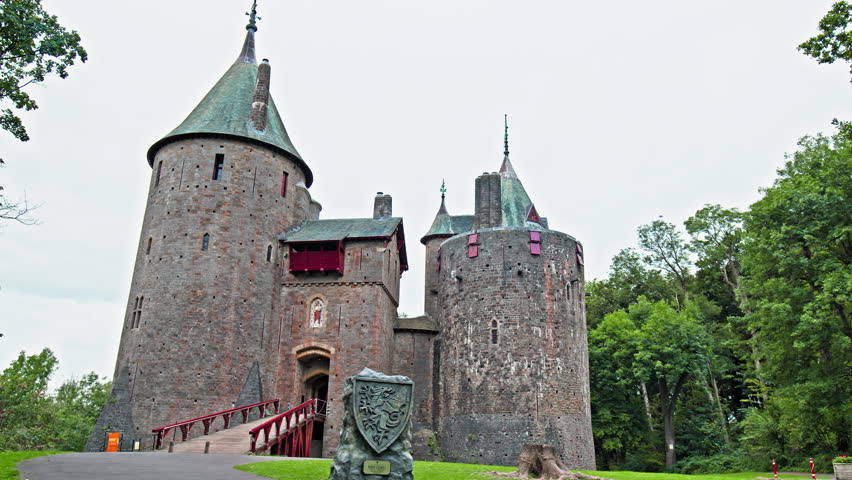 Red Castell Coch with great towers and conical roofs in Cardiff, Wales. Castle built in the gothic-revival style surrounded by ancient beech woods of Fforest Fawr like a vision from a fairy tale
