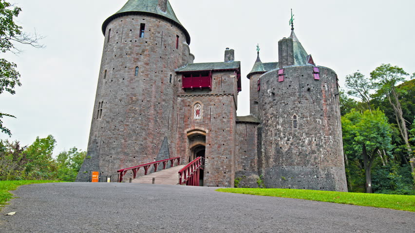 Red Castell Coch with great towers and conical roofs in Cardiff, Wales. Castle built in the gothic-revival style surrounded by ancient beech woods of Fforest Fawr like a vision from a fairy tale
