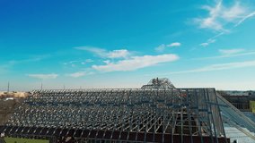 Aerial wide shot of an construction industrial roof, roofers installing a new roof on an industrial building or warehouse. - Powered by Shutterstock - Get 15% off with code: PIKWIZARD15