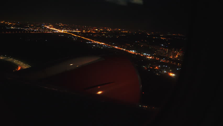 Airplane take off over night sky city lights, view from window sit. Turbine of the plane from the passenger window. White wing airplane taking off. Travel tourism concept. Aircraft vehicle transport | Shutterstock HD Video #1111954821