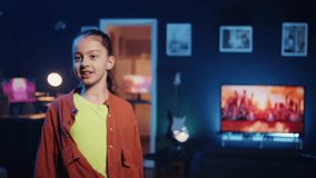 Smiling content creator getting tons of engagement on her dancing clips posts recorded at home. Child filming viral videos in apartment, impressing followers with dance moves, zoom in and out shot