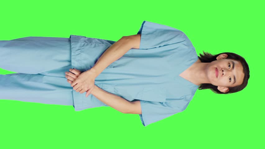 Front view of male nurse nodding on camera and saying yes, showing approval and agreement gesture over greenscreen backdrop. Pleased medical assistant doing good symbol, agreeing with something. | Shutterstock HD Video #1111955555