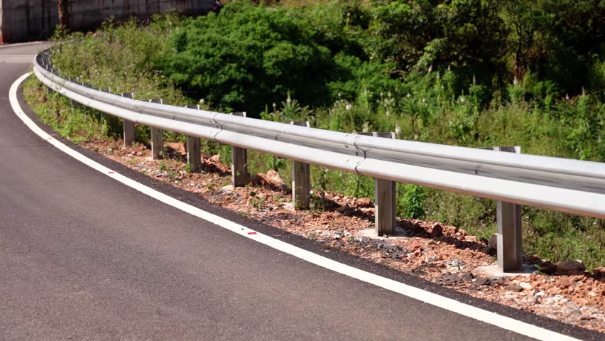 The guard rail, barrier on wayside with cloudy and hill. the straight line from highway fence. image from background, highway fence Royalty-Free Stock Footage #1111959067