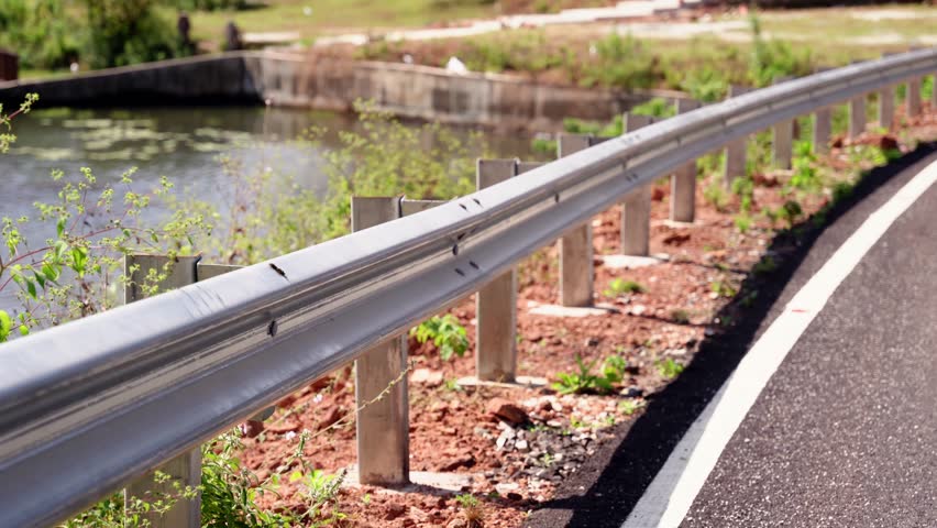 The guard rail, barrier on wayside with cloudy and hill. the straight line from highway fence. image from background, highway fence Royalty-Free Stock Footage #1111959069