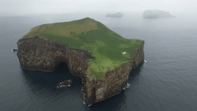 An isolated and desert island in Iceland with a house (cottage).