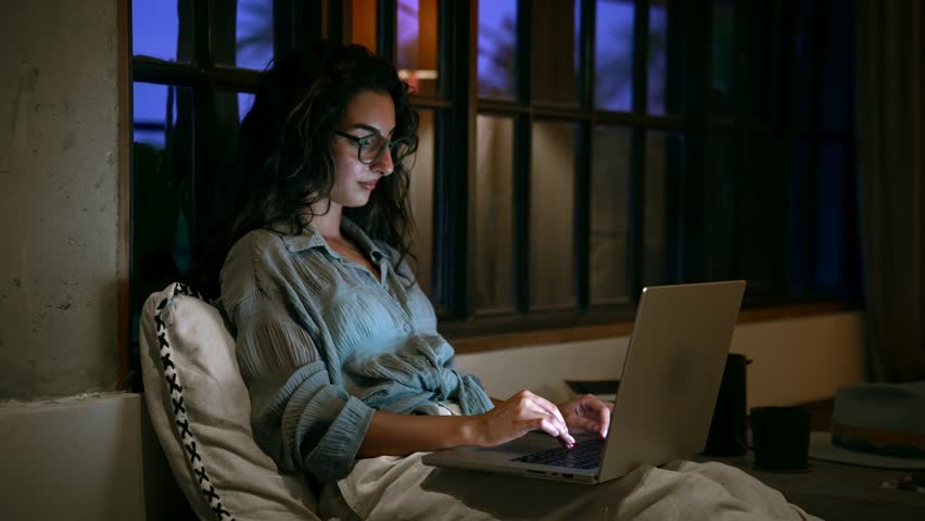 Young Woman Working on Laptop and Typing on Computer Keyboard in Home Office. Serious Female Person Uses Internet Tech in Online Distance Job. Alone Girl in Cozy Space and Portable Display of Notebook - Powered by Shutterstock - Get 15% off with code: PIKWIZARD15
