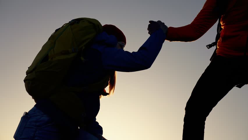 Successful business concept. man and woman together in mountains at sunset. teamwork. business and achieving a goal together. success and help in the team.helping hand to achieve a goal. joint success | Shutterstock HD Video #1111963175