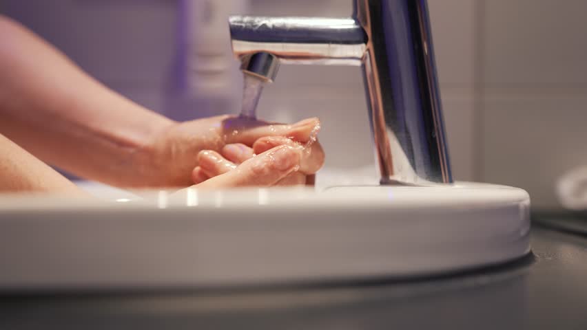 Hygiene concept.personal care and hygiene.prevention of protection against virus.person washes his hands with foam under tap.prevention of protection against virus.palms with soap under running water | Shutterstock HD Video #1111963179