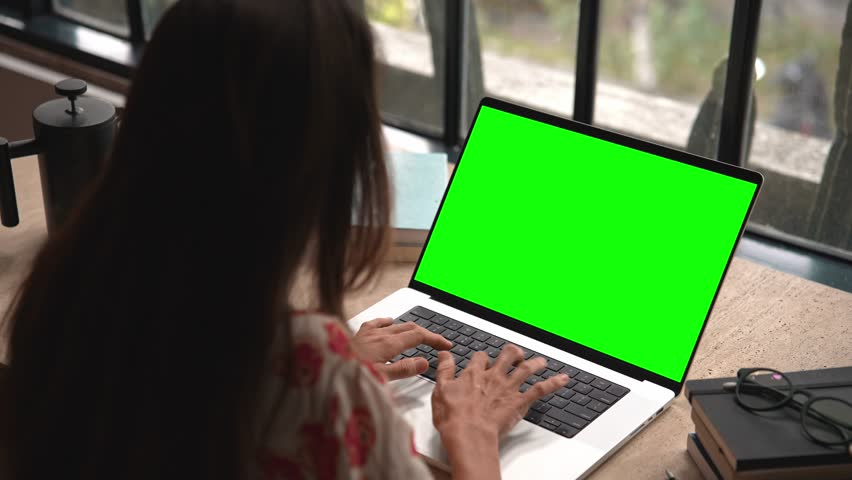 Business Woman Working at Laptop Computer with Green Screen Chroma Key for Mockup. Typing Text on Keyboard or Talking in Internet Messages. Student Studies Homework Content or Speaks Online at Website | Shutterstock HD Video #1111964497