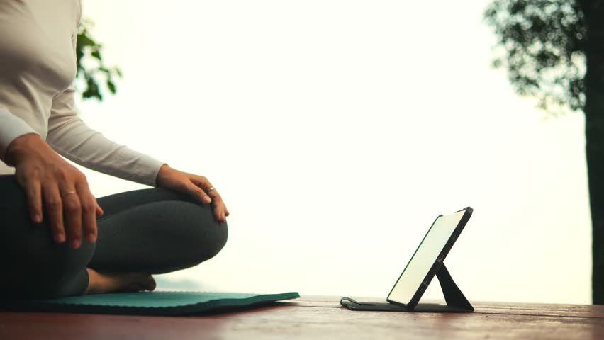 Young Woman Meditates and Sits in Lotus Yoga Pose at Terrace of Cabin in the Woods With Mountain View, High Quality 4K Slow Motion Peaceful Fitness Retreat Activity Concept Footage. Thailand. | Shutterstock HD Video #1111965735