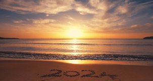 Inspiring morning on tropical beach and rising sun over sea horizon 2024 year text on sea sea sand