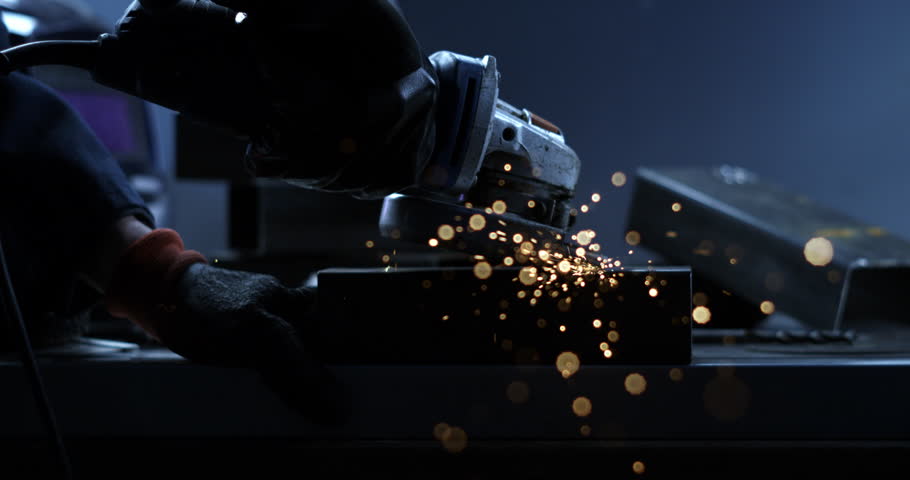 Super slow motion close up of blacksmith welder is smoothing metal steel with industrial angle grinder with flying sparks in workshop. Royalty-Free Stock Footage #1111977275