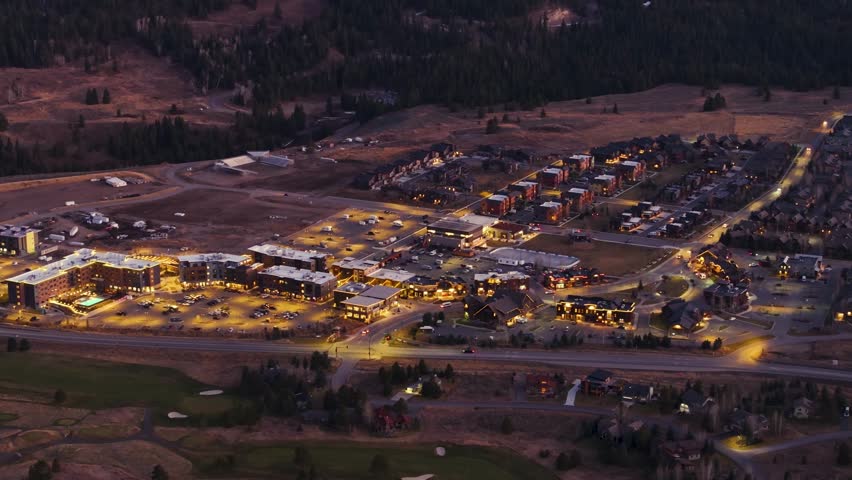 Night time drone shot flyover of Big Sky, Montana busy city center