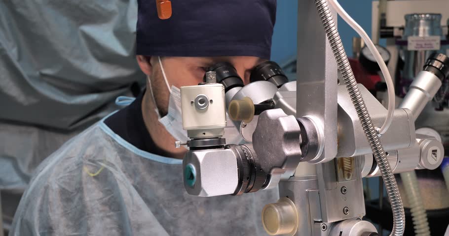 A veterinary ophthalmologist operates on a pet's eye using a microscope. A pet with an eye disease undergoing surgery in a veterinary clinic. Veterinary ophthalmic surgery concept. | Shutterstock HD Video #1111984513