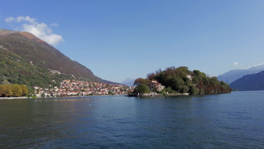 View of Isola Comacina, the only island on Lake Como, from ferry boat. Also see Ossuccio, the neighbor commune on the left. | Shutterstock HD Video #1111985773