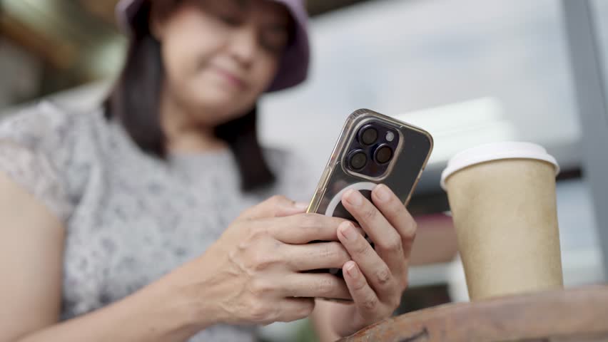 Woman with smartphone and cup of coffee | Shutterstock HD Video #1111985883