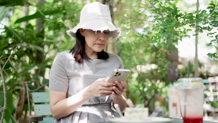 Woman looking at smartphone outdoors | Shutterstock HD Video #1111985909