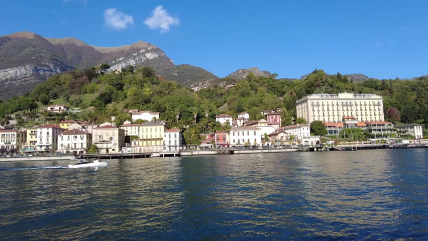 View of Tremezzo town in lake Como, Lombardy, Italy, from ferryboat while cruising pass. Many beautiful architecture which are restaurants and hotel accommodations on waterfront are very impressive. W | Shutterstock HD Video #1111985929