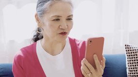 Senior woman looking at smartphone screen