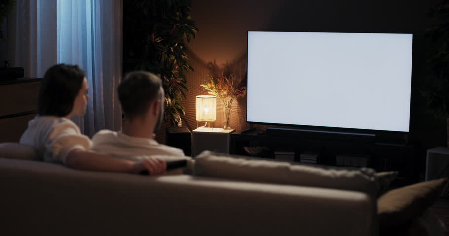 Hapy siblings having nostalgic night in watching old classic singing along to timeless tunes in playful glee, their living room a haven of joy and harmony white screen copy space mockup.