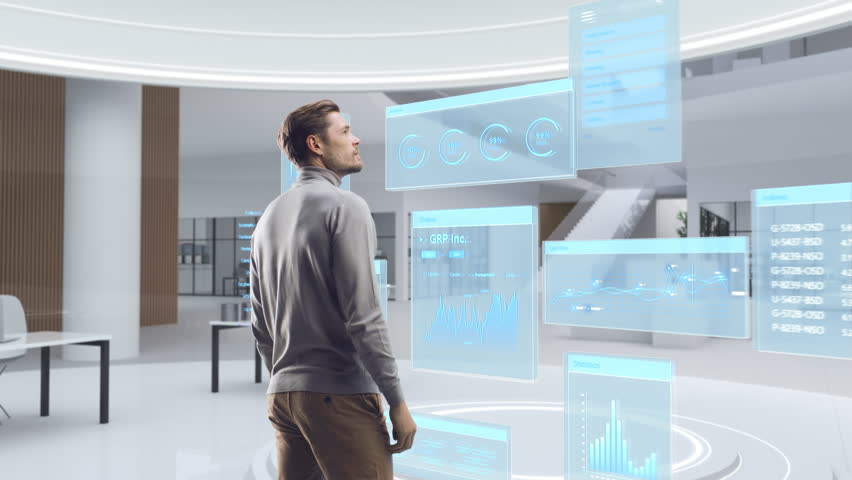 Futuristic Businessman Standing in a Virtual Space, Gesturing with an Augmented Reality Hologram Analysing Big Data, Financial Reports, Stock Market Statistics, Infographics and Charts. Future Concept | Shutterstock HD Video #1111987489