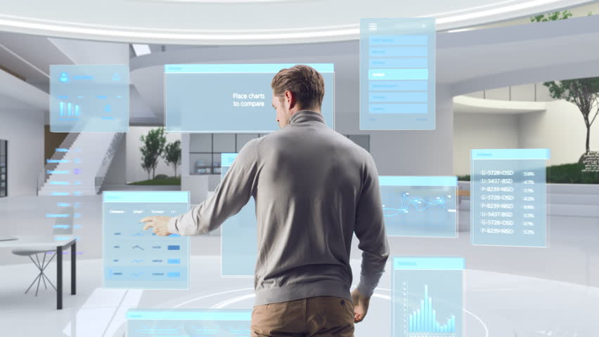 Futuristic Businessman Standing in a Virtual Space, Gesturing with an Augmented Reality Hologram Analysing Big Data, Financial Reports, Stock Market Statistics, Infographics and Charts. Future Concept | Shutterstock HD Video #1111987489