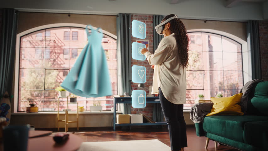 Black Woman Using Virtual Reality Headset for Online Shopping, Browsing through Stylish Dresses and Clothing items. Ordering from Mock-up Internet Store App for e-Commerce products. Augmented Reality | Shutterstock HD Video #1111987491