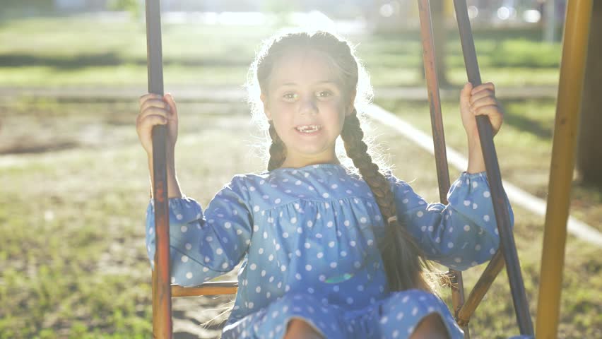Happy family concept.happy child swings on swing on playground in nature.family day.mother swings baby on swing. outdoor games in park. family weekend. mother and child spend time together in the park | Shutterstock HD Video #1111987707