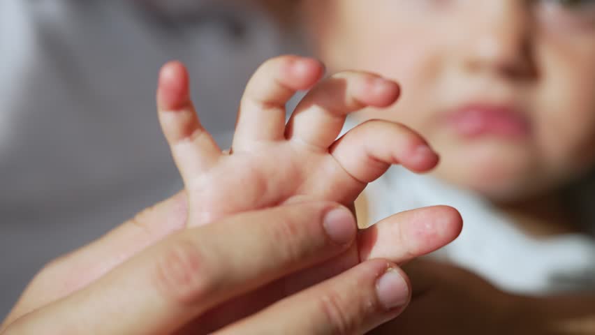 Happy family concept. close-up of the baby hand in the father hand. father day father touches child's little hand. happy baby and dad spend time. father caresses child hand expressing his love | Shutterstock HD Video #1111987711