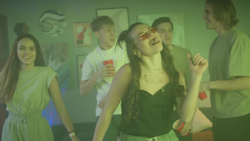 Teenagers friends dancing at home covid lockdown coronavirus party, young students man and woman dance in medical protection masks, celebrating happy birthday or Christmas, lockdown | Shutterstock HD Video #1111987811