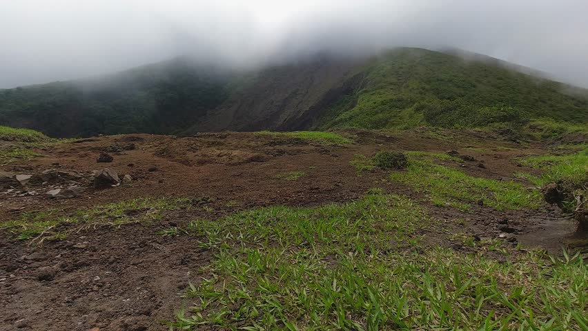 Cloud drifts over mountain summit volcano crater in tropical Nicaragua | Shutterstock HD Video #1111988395