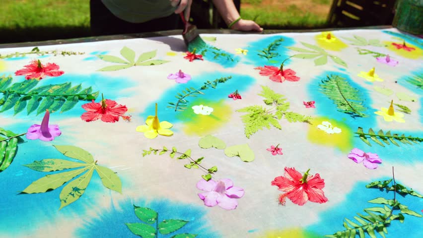 Clients learning homemade batik, sarong, pareo, placing blue paint on leaves on white cloth, Mahe Seychelles 25fps 4. | Shutterstock HD Video #1111988441