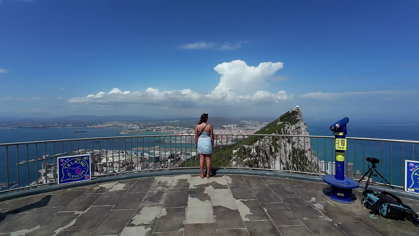 A woman at the Gibraltar Cable Car Top Station overlook in Spain | Shutterstock HD Video #1111988839