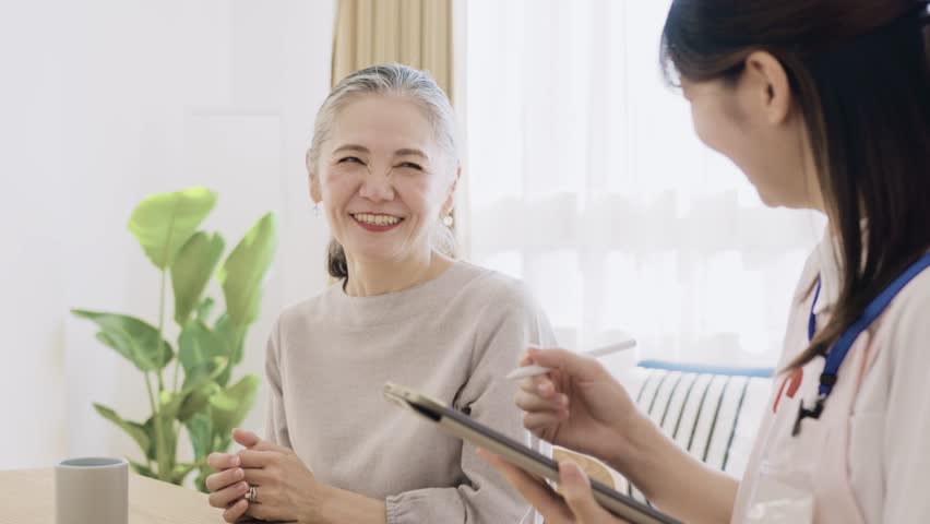 Senior woman and young woman in apron having a conversation Royalty-Free Stock Footage #1111990621
