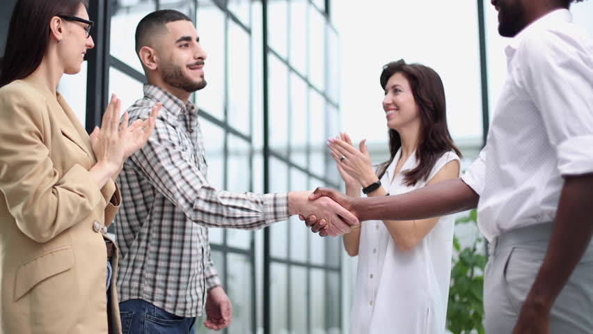 Young businessman shaking hands with a colleague in the corridor | Shutterstock HD Video #1111991097